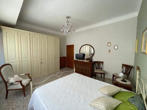 a bedroom with a bed and a dresser and a mirror at Dimora Cadò Alloggio Turistico Privato in Taranto