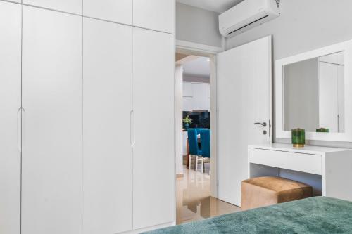 a bedroom with white walls and a mirror at Valeria Private Villa in Plános