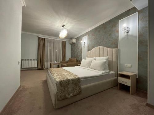 a bedroom with a bed and a living room at DeLin Hotel And Tours in Yerevan