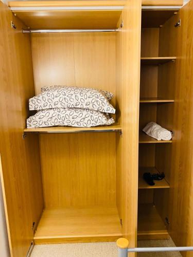 a wooden cabinet with a bed in it at North Greenwhich Homestay in London
