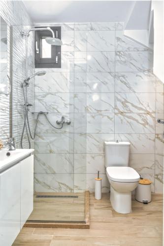 a white bathroom with a toilet and a shower at Valeria Private Villa in Plános