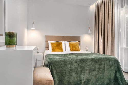 a bedroom with a bed with a green blanket at Valeria Private Villa in Plános