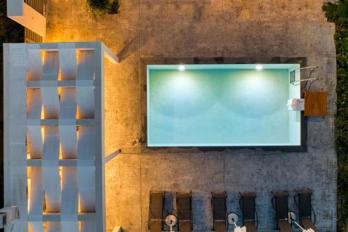 a projection screen on a wall with two people watching a movie at Valeria Private Villa in Plános