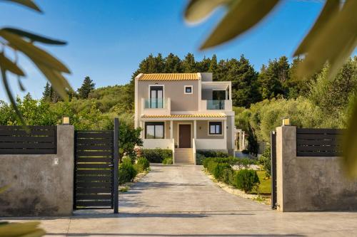 a house with a gate in front of a driveway at Valeria Private Villa in Plános