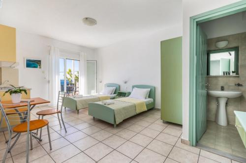 a living room with a couch and a sink at Belvedere Skopelos in Neo Klima