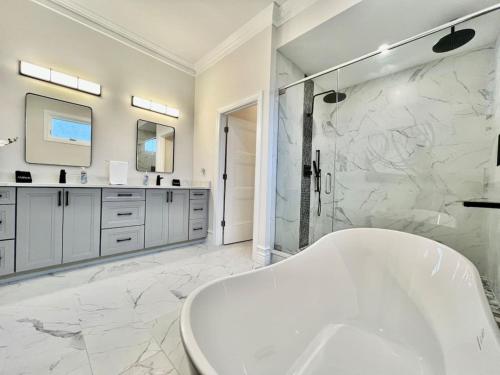 a white bathroom with a tub and a shower at NEW, big, beautiful, Executive Home Liberty Twp in Middletown