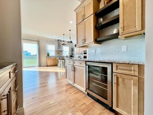 a kitchen with wooden cabinets and a wooden floor at Luxury Home Incredible master suite Liberty Twp OH in Middletown