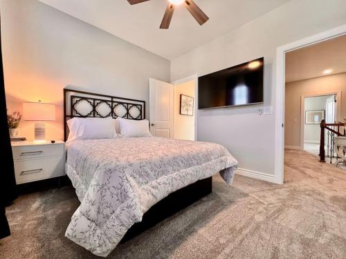 a bedroom with a large bed and a television at Luxury Home Incredible master suite Liberty Twp OH in Middletown