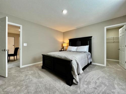 a bedroom with a large bed with a black headboard at Brand new Executive home in Liberty Twp, Ohio in Maustown