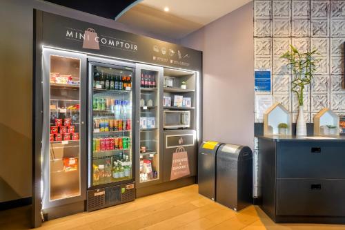a store with a refrigerator with drinks in it at Campanile Paris Ouest - Pont de Suresnes in Suresnes