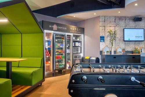 a shop with green walls and sinks in a store at Campanile Paris Ouest - Pont de Suresnes in Suresnes