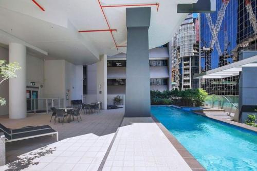 a large building with a swimming pool in a city at Lux Sub-Penthouse with Casino views in Brisbane