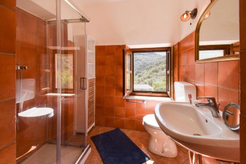 a bathroom with a sink and a toilet and a shower at Duca House in San Giovanni