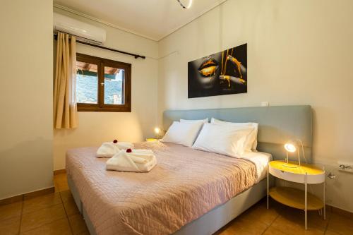 1 dormitorio con 1 cama con 2 toallas en Stoupa Serene Nests - Spitiko Getaway, en Stoupa