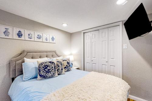 a bedroom with a bed with blue and white pillows at Houston Hideaway - Unit B in Houston