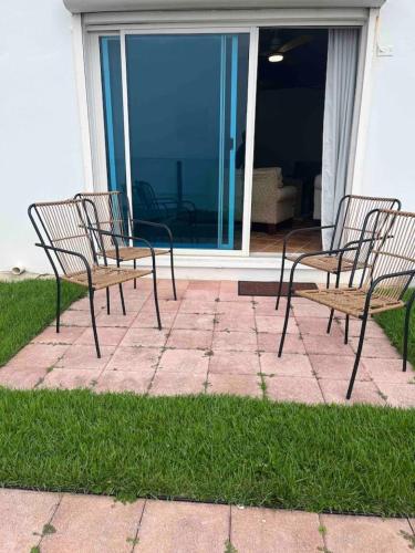 a group of chairs sitting on a patio at Beachfront Luxury Apartment in Aguada