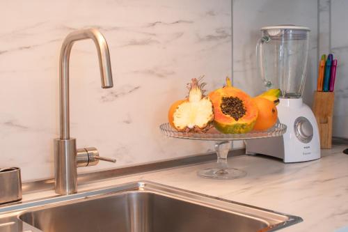a kitchen sink with a plate of pumpkins and a blender at CASA PAZ - COZY 2 BEDROOM APARTMENT CLOSE TO DORADA BEACH in Playa Blanca