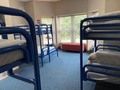 a room with several bunk beds in a dorm room at The Connemara Hostel - Sleepzone in Leenaun