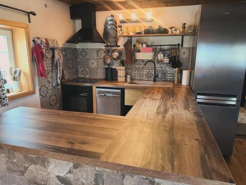 a kitchen with a wooden counter top in a room at Chata "Na pohodu" in Chřibská