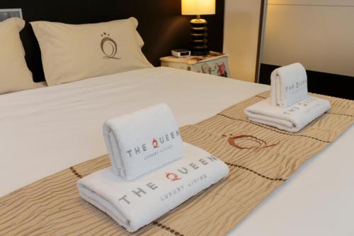 a hotel room with two towels on a bed at The Queen Luxury Apartments - Villa Marilyn in Luxembourg
