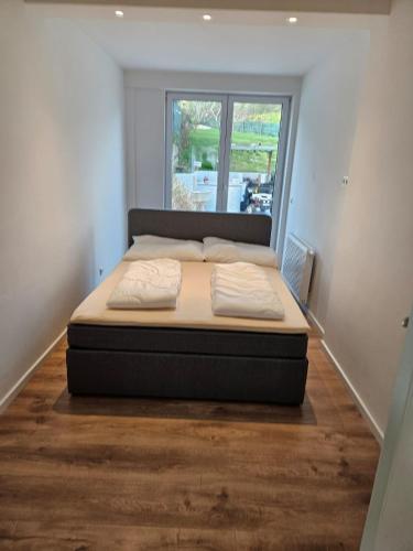 a large bed in a room with a window at GardenLoft no2 in Vienna