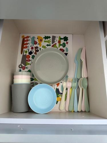 a shelf with a plate and utensils in a kitchen at Encanto house with king bed in Isabela