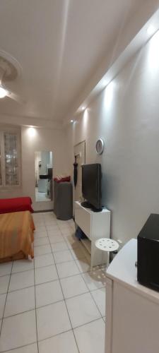 un salon avec un canapé et une télévision dans l'établissement Studio dans la Villa 