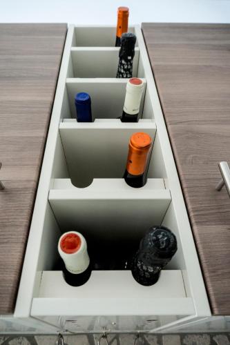 a drawer filled with different types of wine bottles at The Queen Luxury Apartments - Villa Marilyn in Luxembourg