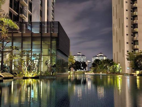 a building with a pool of water in front of buildings at NEW Elegant & Cozy Greenfield Home near Sunway 2-6pax in Petaling Jaya