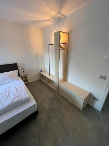 a bedroom with a bed and a mirror on the wall at Agriturismo B&B Caffè e Vino in Sondrio