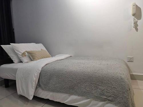 a bedroom with a bed with white sheets and pillows at NEW Elegant & Cozy Greenfield Home near Sunway 2-6pax in Petaling Jaya