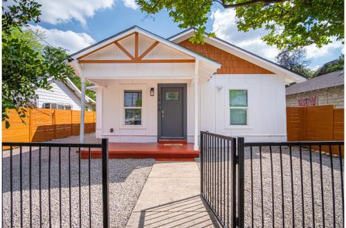 a small white house with a black fence at Charming 3BR1BA Close to Vibrant Downtown in San Antonio