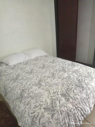 a bed with a white blanket and a pillow at Hermoso de´partamento, Un lugar para descansar in Ocotlán