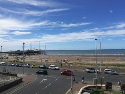 a road with cars parked next to the beach at South Beach Kings Promenade Hotel in Blackpool