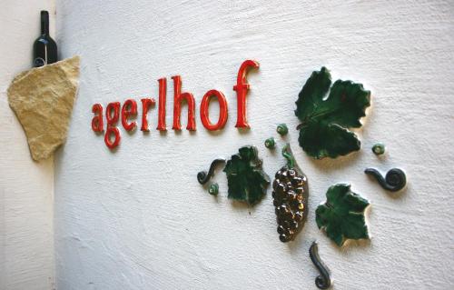 a white surface with the word exhibit and some vegetables at Winzerhof Agerlhof in Jois