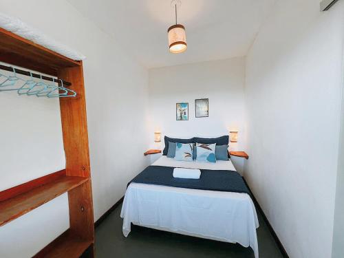 a bedroom with a bed in a white room at Vila Boa Vista Itacaré in Itacaré