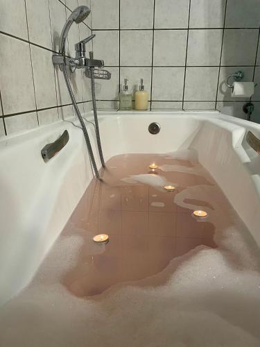 a bath tub filled with water in a bathroom at Igoumenitsa Retiré Apartment in Igoumenitsa