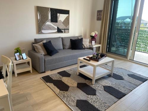 a living room with a couch and a table at A Place to Stay 1BR Waters Edge Theme Parks, Yas Island in Abu Dhabi