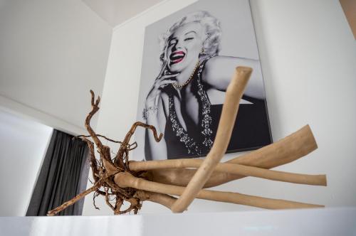 a pile of cinnamon sticks and a picture of a woman at The Queen Luxury Apartments - Villa Marilyn in Luxembourg