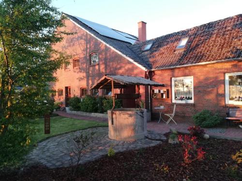 a brick house with a grill in the yard at Ferienhaus Bonishof in Westerholt