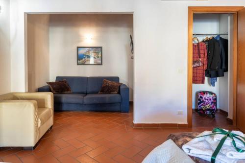 a living room with a blue couch in a room at La Dimora nell'Anfiteatro Superior room and apartment Self check in Elevator Air Conditioning in Lucca
