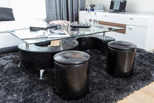a glass table and stools in a living room at The Queen Luxury Apartments - Villa Marilyn in Luxembourg