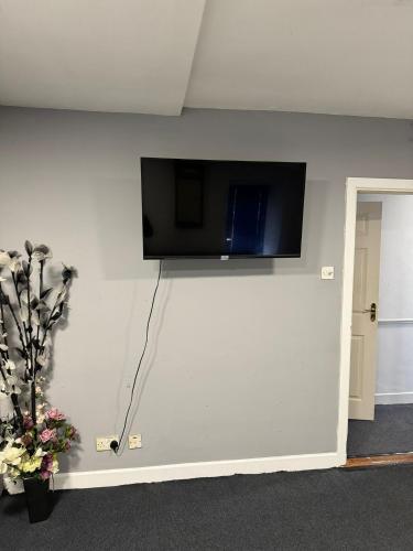 a wall with a flat screen tv on a wall at Habibi House in Longford