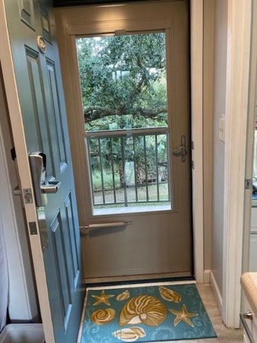 a hallway with a door with a window and a rug at PB B204 - Close to Beach - Optional Boat Slip in Fort Walton Beach