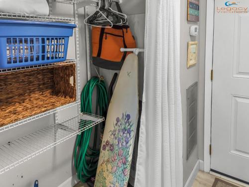 a closet with a surfboard in a room at PB B204 - Close to Beach - Optional Boat Slip in Fort Walton Beach
