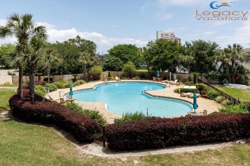 a swimming pool in a park with trees and bushes at PB B204 - Close to Beach - Optional Boat Slip in Fort Walton Beach