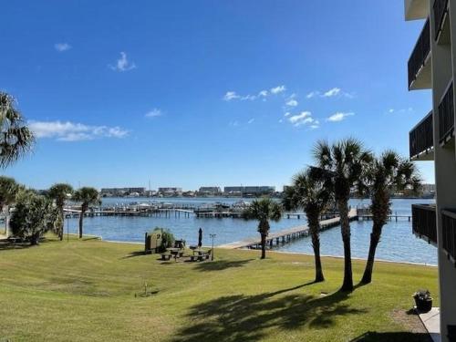 a view of a body of water with palm trees and a dock at PB B204 - Close to Beach - Optional Boat Slip in Fort Walton Beach