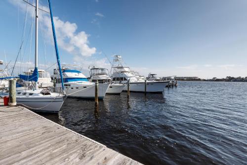 a group of boats docked at a dock in the water at PB B204 - Close to Beach - Optional Boat Slip in Fort Walton Beach