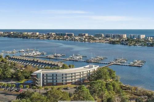 a large building next to a marina with boats in the water at PB B204 - Close to Beach - Optional Boat Slip in Fort Walton Beach