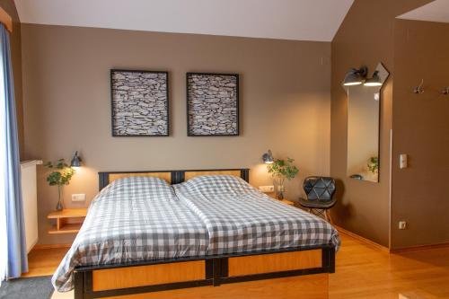 a bedroom with a bed and two windows on the wall at Pension Kärnten in Seeboden